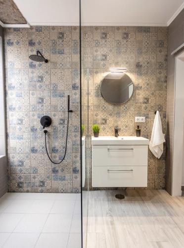 a bathroom with a shower and a sink at Castanheiro in Lagoa