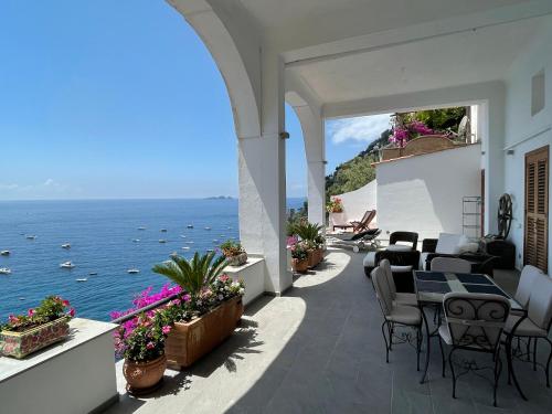 a patio with a view of the ocean at Casa Antioco Original in Positano