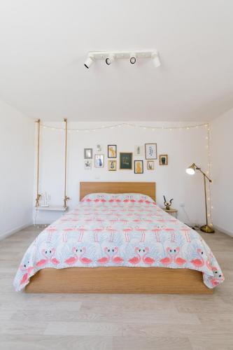 a bedroom with a bed with a pink comforter at Flamingo B&B in Pompei