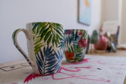 two coffee cups are sitting on a table at Flamingo B&B in Pompei