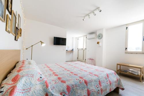 a bedroom with a bed in a white room at Flamingo B&B in Pompei