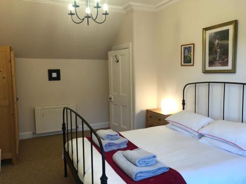 a bedroom with a bed with towels on it at 4 bedroom townhouse Kirkcudbright in Kirkcudbright
