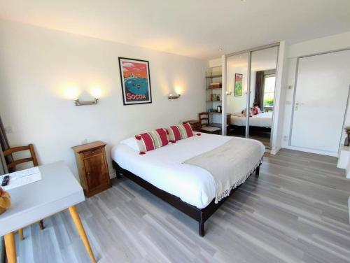 a bedroom with a bed and a woman in a room at Les Digues Vauban in Ciboure