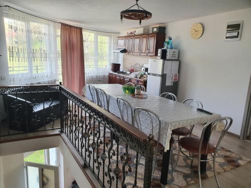 a kitchen and dining room with a table and chairs at Casa Destinatia Perfecta in Braşov
