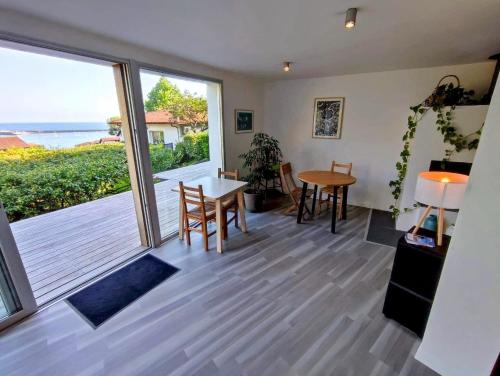 a living room with a table and a view of the ocean at Les Digues Vauban in Ciboure