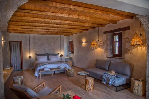 a bedroom with a bed and a couch in a room at Brazzo di Maina in Oítilon