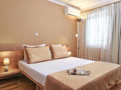 a bedroom with a bed with a tray on it at Achi's House in Lefkada