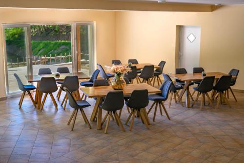 a conference room with wooden tables and chairs at Zelena Oaza in Zgornja Kungota