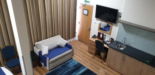 a small room with a room with aurymarked at PremierLux Serviced Apartments in Ilford