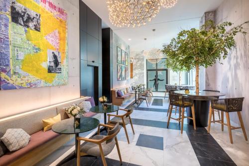 a restaurant with tables and chairs and a map on the wall at Barceló Imagine in Madrid