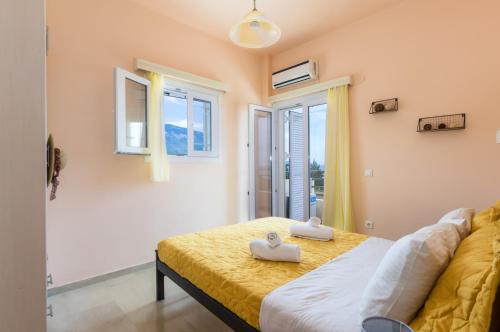 a bedroom with a bed with two towels on it at Asta La Vista Maisonettes in Pesádha