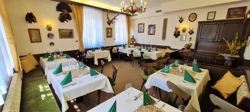 a restaurant with tables and chairs in a room at Hotel Kaiser Franz Josef in Rohr im Gebirge
