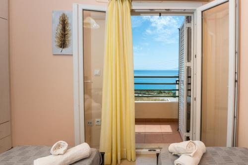 a bedroom with a view of the ocean at Asta La Vista Maisonettes in Pesádha