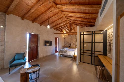 a bedroom with a bed and a blue chair at Brazzo di Maina in Oítilon
