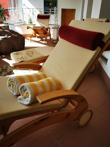 a chair with towels on it in a room at Hotel Alpenhof in Bad Wörishofen