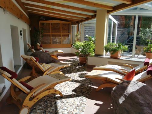 a group of chairs sitting on a patio at Hotel Alpenhof in Bad Wörishofen