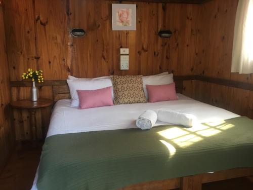 a bedroom with a bed with two towels on it at Smiths Cottage in Durban
