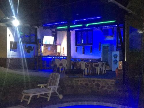 a house at night with a chair and lights at Smiths Cottage in Durban
