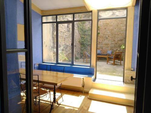 ein Esszimmer mit einem Tisch und einem Fenster in der Unterkunft Appartement au coeur du village- Ref12 in Saint-Paul-Trois-Châteaux