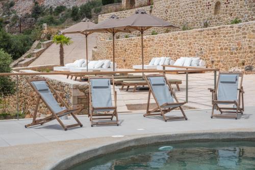 a patio with a table and chairs and a pool at Brazzo di Maina in Oítilon