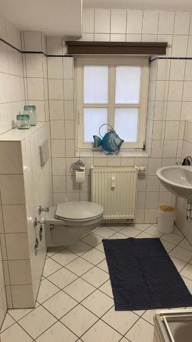 a bathroom with a toilet and a sink at Apartment Häuserstraße 15 in Northeim