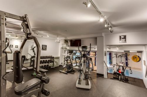 a gym with several treadmills and machines in a room at Park Town Hotel in Saskatoon