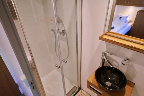 a bathroom with a shower and a toilet at Hotelboat Iris in Amsterdam