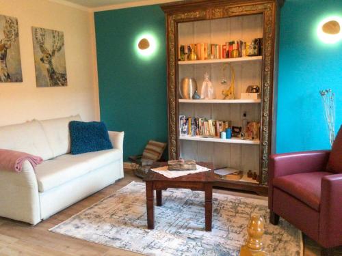 a living room with a couch and a table and a mirror at Ferienwohnung Schubertstraße in Malchow