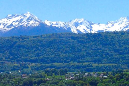 a mountain range with snow capped mountains in the background at Le Belvédère : chambres et table d'hôtes in Montmélian