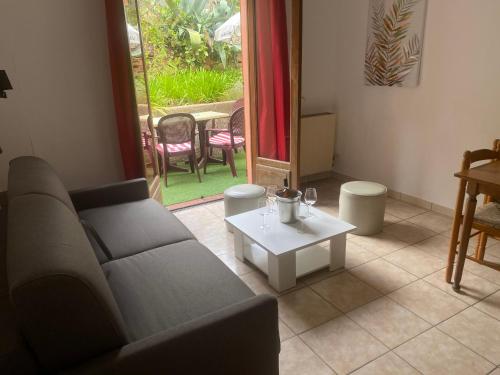 a living room with a couch and a table at Apparthotel Le Porto in Porto Ota