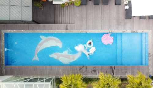 a swimming pool with a mermaid painted on it at Grand Fleuve Boutique in Ha Long