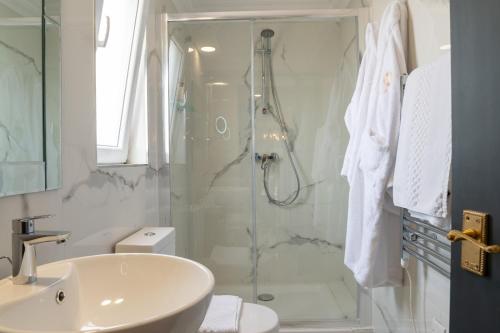 a bathroom with a shower and a toilet and a sink at Julina Boutique Living in Mosta