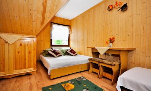 a bedroom with two beds and a desk in a room at U Kaśki in Biały Dunajec