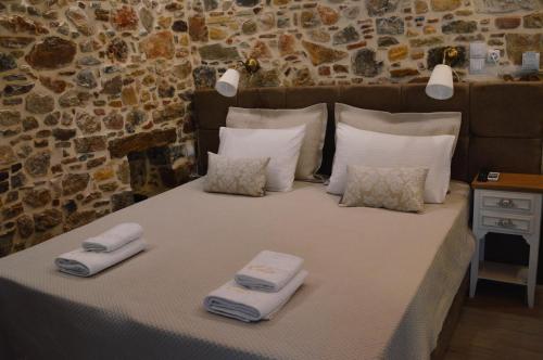 a bed with two towels on top of it at Castro Rooms Chios in Chios