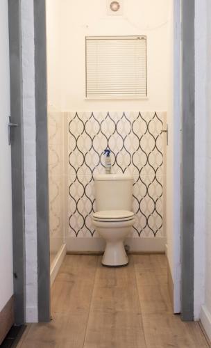 a bathroom with a toilet in a room at 16 st Johns - Apartment in Port Shepstone