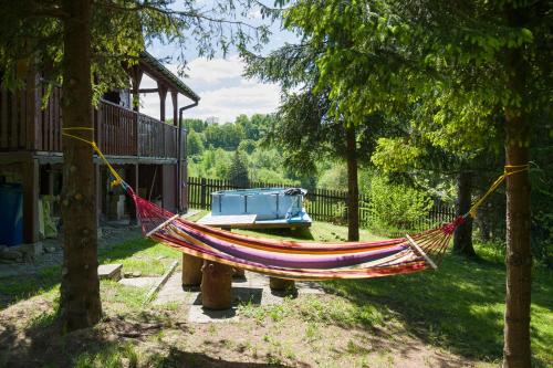 a hammock in a yard next to a house at Andrzejówka in Kocoń