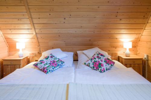 a bedroom with two white beds with pillows on them at Andrzejówka in Kocoń