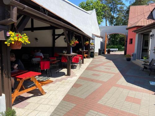 a patio with tables and chairs and a building at Penzion a Restaurace Na Jízdárně in Kroměříž
