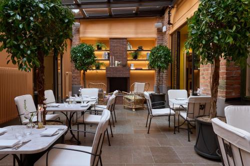 a restaurant with tables and chairs on a patio at Villa Dagmar in Stockholm