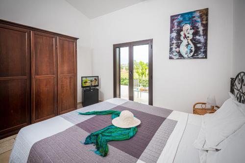 a bedroom with a bed with a hat on it at Locanda del Pino in Ginosa Marina