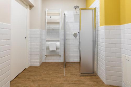 La salle de bains est pourvue d'une douche et d'un miroir. dans l'établissement Aqualago casa vacanze apartment A, à Verbania
