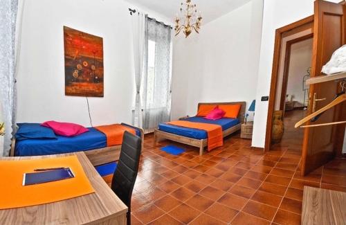 a living room with two beds and a table at Borgo 98 Guest House Tripla con bagno privato in Livorno
