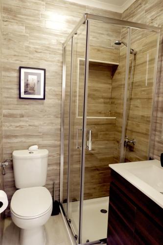 a bathroom with a toilet and a glass shower at PenicheArtHouse in Peniche