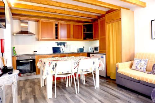 a kitchen with a table and chairs and a couch at PenicheArtHouse in Peniche