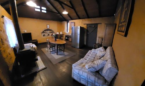 a living room with a couch and a table at The Gate House in Hoddy Well