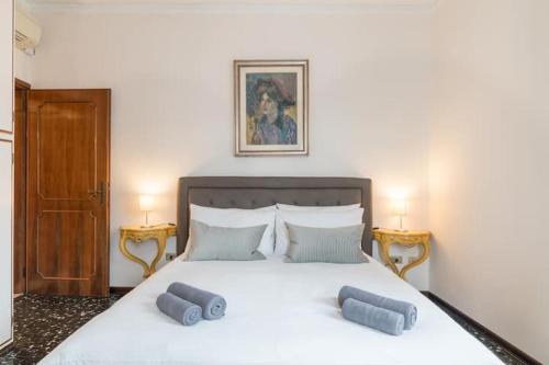 a bedroom with a large bed with two pillows on it at Ca’ Pesaro rooftop terrace apartment. in Venice