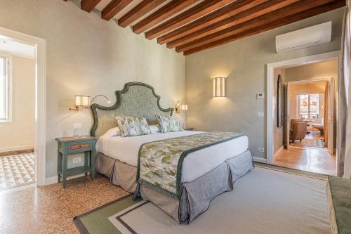 a bedroom with a large bed in a room at L'Opera Divina- Dimora Italia - in Venice