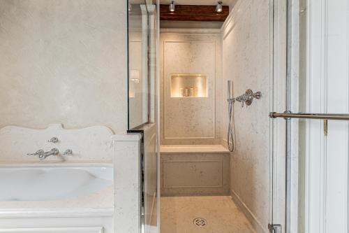 a bathroom with a bath tub and a sink at L'Opera Divina- Dimora Italia - in Venice