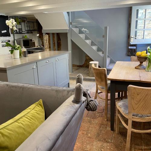 a living room with a couch and a table at Box Barn - Stylish Accommodation in Rutland in Uppingham
