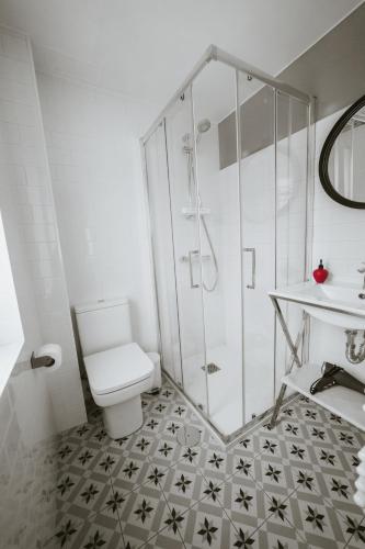 a bathroom with a shower and a toilet and a sink at Mía's Home in León